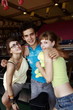 Teenagers posing at game in arcade