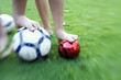 Photo: Two children's legs with balls Two children's legs with balls