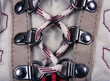 Close up view of a hiking shoe, showing laces in detail.