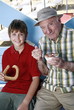 Photo: Grandfather and grandson eating at beach *** Local Caption *** Young and old living a healthy lifestyle. Grandfather and grandson eating at beach *** Local Caption *** Young and old living a healthy lifestyle.