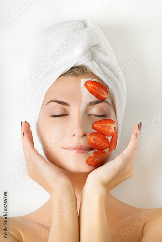 Beautiful woman with fruit mask on her face