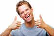 Casual young man showing thumbs up sign,and smiling