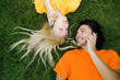 Couple lying on the grass with mobile phones