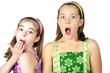 Two cute little girls with a surprised look on their faces