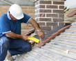 Close-up of trainee roofer on mock building site