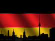 Berlin skyline with tv tower against rippled German flag Berlin skyline with tv tower against rippled German flag