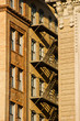 brownstone fire escape in between two buildings