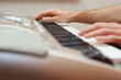 hands playing music on the piano,  keyboard