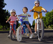 Sisters riding bikes together and laughing