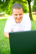 Happy Young Man Smiling To Laptop