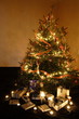 Christmas presents and candles under the tree Christmas presents and candles under the tree