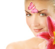 Quadro Beautiful young woman with pink lily close-up portrait