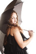 Girl in black dress with umbrella isolated over white
