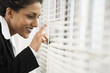 Foto: A business woman looking out from a window. A business woman looking out from a window.