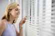 Foto: A business woman looking out from a window. A business woman looking out from a window.