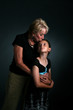 grandmother kissing granddaughter on forehead grandmother kissing granddaughter on forehead