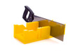 A small yellow miter box or saw on a white background