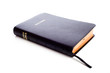A black leather Holy Bible on a white background with copy space