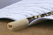 Wooden flute laying on opened book with music sheets