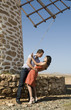 man and woman dancing near a windmill