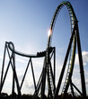 Steel Built Sitdown Rollercoaster Against Blue Sky Steel Built Sitdown Rollercoaster Against Blue Sky