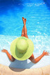 Young woman sittingin a swimming pool
