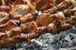 Pieces of pork shish kebab on skewers above ashes Pieces of pork shish kebab on skewers above ashes