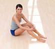 Portrait of a beautiful smiling young lady sitting on floor