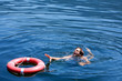 Photo: A man struggling for a life buoy in the water A man struggling for a life buoy in the water