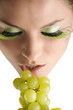 close up of a young girl and beautiful girl with grape near