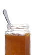 Peach jar opened with a spoon, isolated on white background Peach jar opened with a spoon, isolated on white background