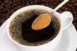 A teaspoon of brown sugar over a cup of black coffee