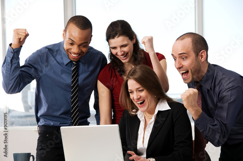 Photo: group of business people at an office desk group of business people at an office desk