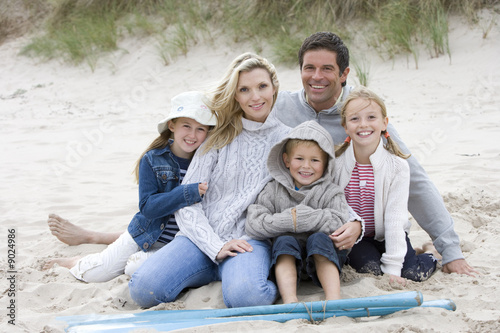 Photo: Portrait of young family on beach Portrait of young family on beach