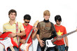 Portrait of young trendy group with musical intruments