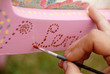 hand with a brush painting some letters