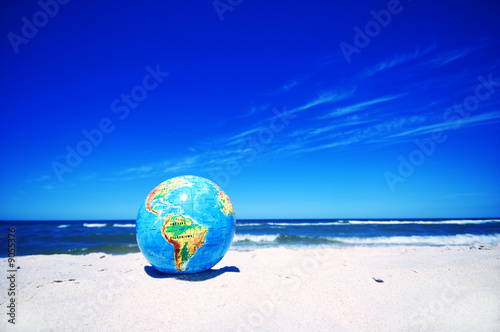 Photo: Earth globe on the beach. Ideal for Earth protection concepts Earth globe on the beach. Ideal for Earth protection concepts
