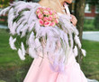 bride is holding flower bouquet at the wedding reception