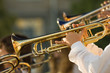 young musicians are playing on trombones