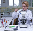 Female researcher looking at a test tube