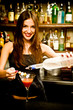 A young female bartender, photographed at work.
