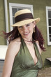 Photo: Beautiful woman in a summer hat leaning against an automobile Beautiful woman in a summer hat leaning against an automobile