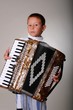 Young boy playing a 48 base accordion