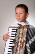 Young boy playing a 48 base accordion