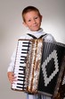 Young boy playing a 48 base accordion
