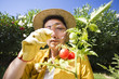 Photo: Senior woman looking at tomato with magnifying glass Senior woman looking at tomato with magnifying glass