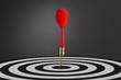 Portrait shot of a Red dart on bull's eye of a dart board Portrait shot of a Red dart on bull's eye of a dart board