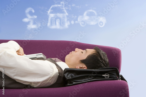 Photo: Businessman daydreaming about success Businessman daydreaming about success