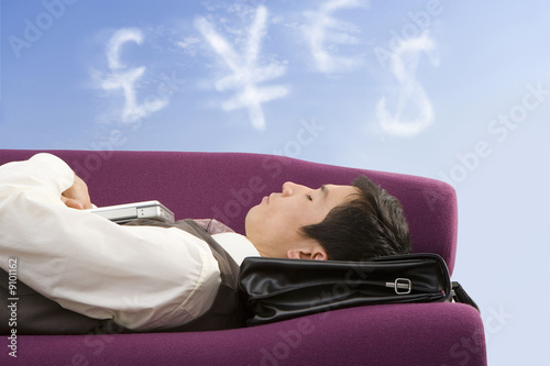 Photo: Businessman daydreaming about money Businessman daydreaming about money