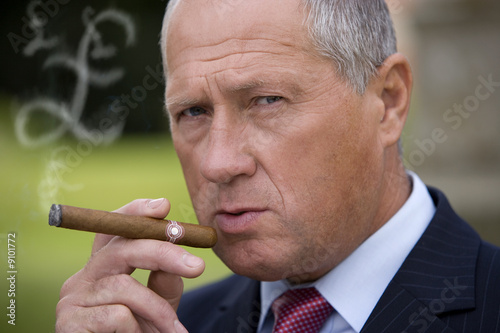 Photo: Businessman smoking cigar Businessman smoking cigar